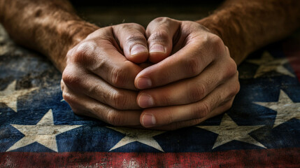 Fototapeta premium Hands Clasped in Prayer on an American Flag Representing Hope, Faith, and Patriotism