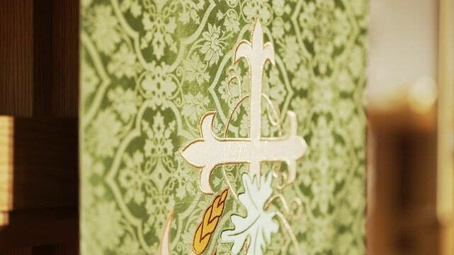 A green and gold Celtic cross inside of a catholic church before mass.