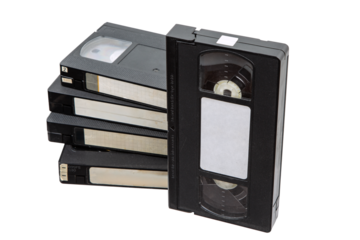 Stack of vintage VHS tapes, black plastic, blank labels, retro media, isolated on white background, nostalgic, analog technology.