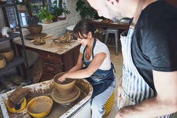 Class, learning and people with pottery wheel, clay or talent for handmade product, teacher or...