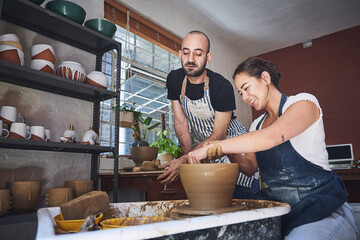 Lesson, teacher and woman with pottery wheel, clay and talent for handmade product, learning or...