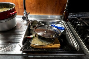 Dirty kitchen utensils in a jersey ready to be washed