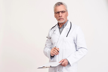 Portrait of serious doctor with stethoscope and clipboard isolated.