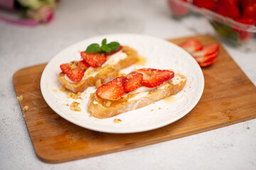 Strawberry and cottage cheese sandwich on white table