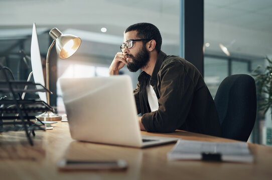Computer, reading and glasses with business man in office for web designer, ux tools or planning. Coding homepage, night and developer with person in tech agency for cms platform, research and laptop