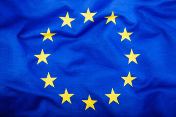 European Union flag in iridescent sunlight, close-up.