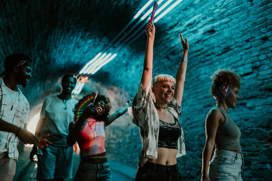 Young people dancing and celebrating at music festival