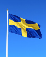 Swedish flag waving against clear blue sky