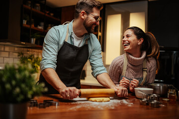 Couple enjoying baking together in cozy kitchen