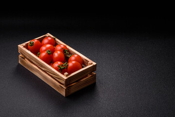 Ripe red cherry tomatoes in a wooden box