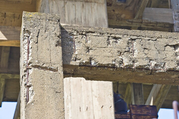 Old and damaged reinforced concrete beam and pillar with poor an