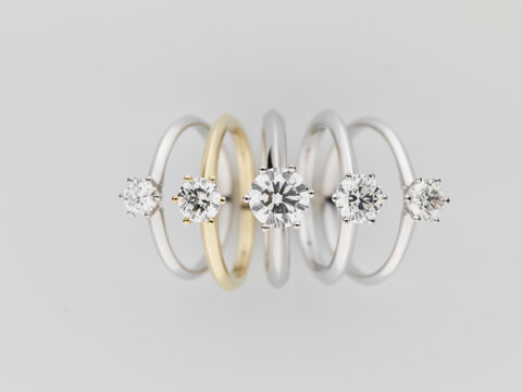 Wedding rings on top of white pedestal.