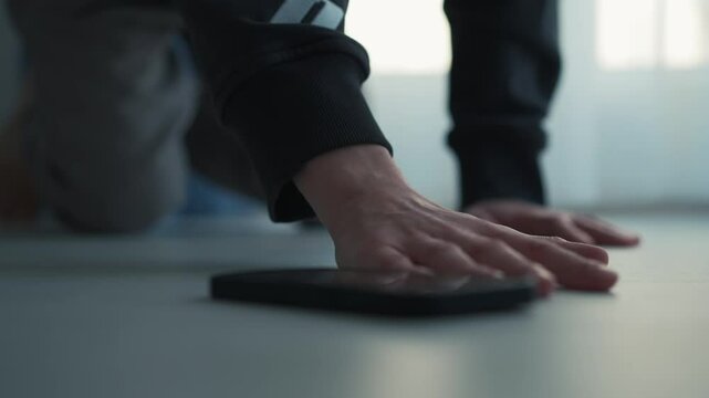 A blind man has dropped his phone on the floor and is trying to feel it with his hand.
A man is looking for his phone.
Smartphone on the floor.
The guy picks up the phone from the floor.
Raise