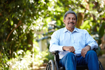Elderly man, wheelchair and smile in park, portrait and outdoor with injury, recovery and relax in...