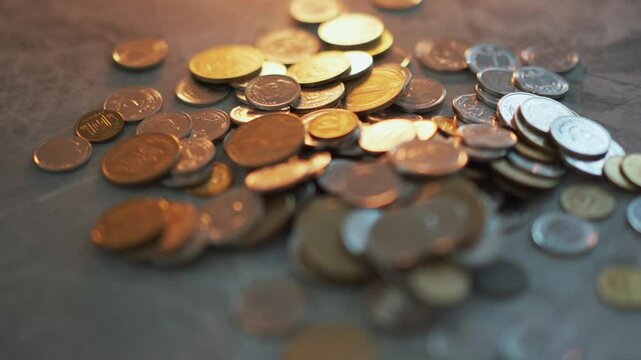 pennies scattered on the table.
Many coins lie on the table.
A lot of money on a gray table.
A pile of metal pennies on the surface.
Cash savings close up.
Money, pennies, coins, cash