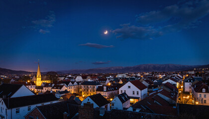 Naklejka premium Dreamy village under new crescent moon at night, tranquil serenity