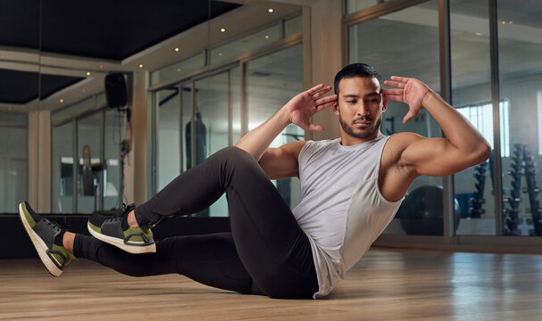 Athlete, man and side sit up with exercise at gym for core strength, muscle growth and body balance. Active, male person and bicycle crunches with fitness training, sports workout and ab development