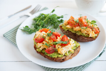 Bruschetta with egg, avocado and herbs for breakfast. Healthy and healthy breakfast, lunch and snack on a plate.