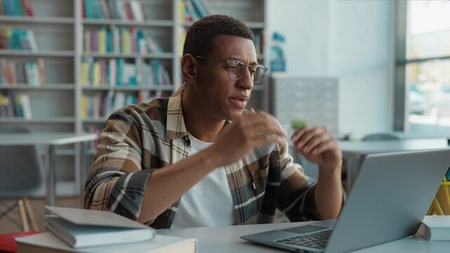 African American man student library laptop desktop computer gadget guy holding head tired overworked worker internet exhaustion anxiety lost connection problem deadline occupation male frustration pc