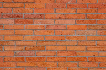 Obraz premium Red brick wall texture background, cement joints, and an aged