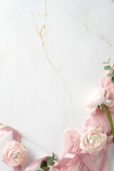 Elegant marble background with delicate pink flowers, eucalyptus leaves, and a pink ribbon, perfect for wedding invitations, romantic designs, and feminine-themed project