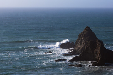 A sharp outcrop on the shore of California.