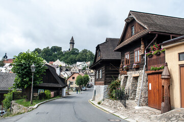 Street of the city of Stramberk, Czech Republic with old historic houses with a stone tower on the hill above the city.
