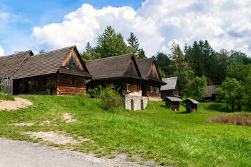 Old wooden houses on a meadow in a small mountain village. Roznov, Czech Republic.