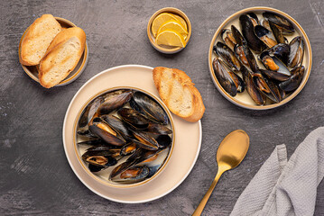 Food photography of mussels with garlic and butter sauce, lemon, toasted bread, seafood appetizer with creamy sauce, starter