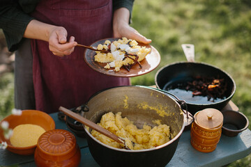 Rustic Outdoor Cooking Scene Featuring Polenta Preparation and Presentation