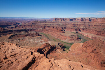 A winding river in the red southwestern landscape of Utah.