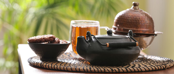 Tea pot and cookies on table in cafe