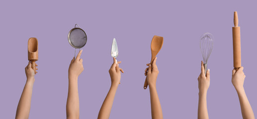 Female hands with baking utensils on lilac background