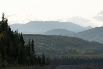 Road trip through the majestic canadian rockies: coniferous forests and mountain ranges at sunset