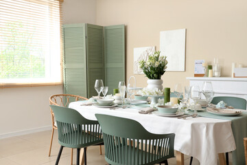 Beautiful table setting with white flowers for wedding celebration in room