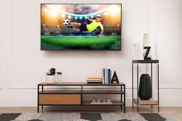 Soccer game playing on TV set in room