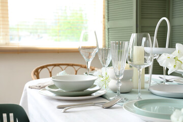 Beautiful table setting with white flowers for wedding celebration in room, closeup