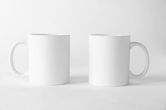 Two blank mugs on white background. Mockup for design