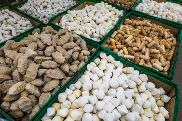 Different types of qurut in boxes on the counter of an Asian market, high angle view. Qurut - is a fermented dried hard yogurt balls, traditional meal in Central Asia