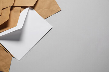 Paper envelopes on gray background, flat lay. Mockup for design