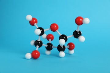Molecule of glucose on light blue background. Chemical model