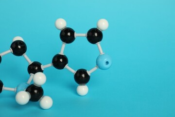 Chemical model of molecule on light blue background, closeup. Space for text