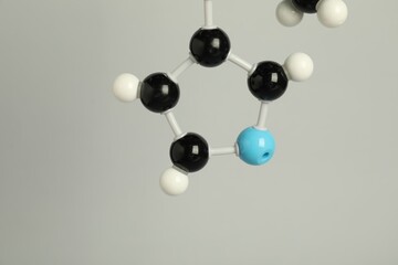 Chemical model of molecule on light grey background, closeup