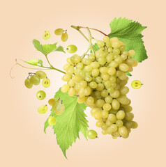 Obraz premium Fresh grapes in air on dark beige background
