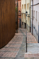 Narrow cobblestone street in historic district with modern wooden architecture, Soria, Spain