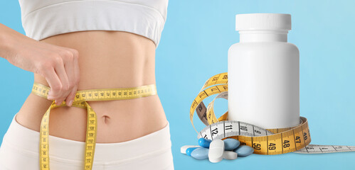 Weight loss. Slim woman measuring her waist with tape and pills on light blue background, closeup