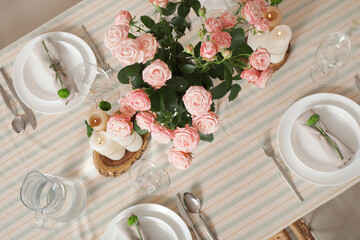 Stylish table setting with flowers in dining room. Top view