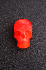 Red ice in the shape of a human skull on a black background