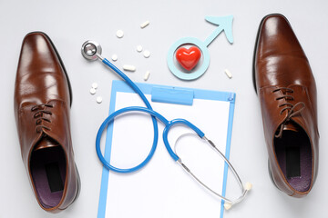 Shoes, stethoscope, clipboard, heart and male sign on grey background. Prostate cancer awareness