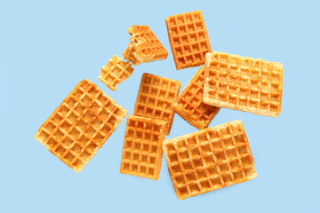 Falling waffles on light blue background